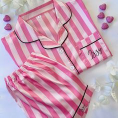 Our bestselling personalised pyjamas look just like Victorias Secret for half the price! Glamorous Pink and White Stripes with a button front, shirt collar and decorative piping. They are easy fit and are personalised with your name on the shirt pocket and also on the bottom of the trousers. Our luxe satin pyjamas are perfect to celebrate special occasions such as Birthdays, Hen Parties, Weddings, Valentines and Galentines. If you would like to bulk buy for a whole hen party such as The Bride, M Personalised Pyjamas, Satin Pyjamas, Barbie Gifts, Shirt Style Tops, Pyjama Satin, Personalized Pajamas, Victoria Secret Outfits, Matching Pjs, Victoria Secret Pajamas