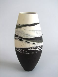 a black and white vase sitting on top of a table