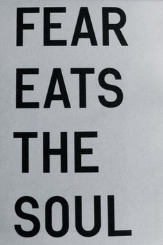 there is a sign that says fear eats the soul in black and white letters on it