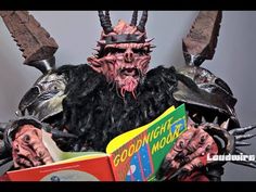 a man in costume reading a book while wearing horns