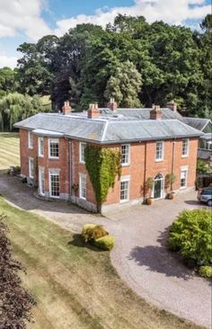 an aerial view of a large brick house