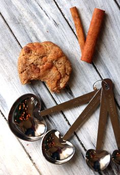 spoons, cookie and cinnamon on a wooden table