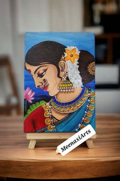 a painting on a wooden stand with a name tag