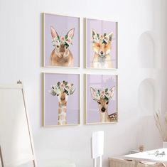 three pictures of animals with flowers on their heads are hanging on the wall above a desk