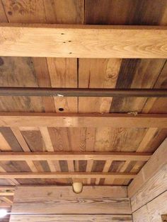 the ceiling is made out of wood planks and has two lights on each side