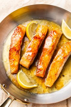 some fish and lemons are in a pan