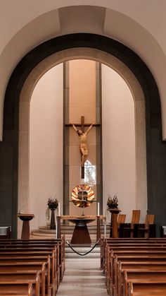 the inside of a church with pews and a crucifix