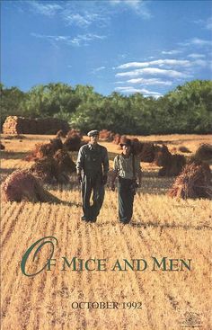 an image of two men standing in the middle of a field with hay bales