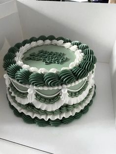 there is a green and white cake in the box