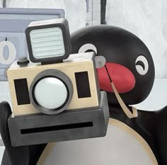 a penguin with a camera attached to it's neck