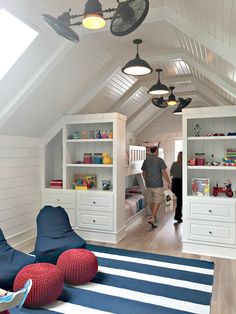 an attic bedroom with white walls and blue carpeting, built in bookshelves