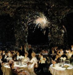 a group of people sitting at tables with fireworks in the background