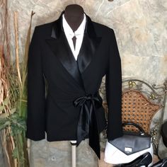 Jones New York Dress Black Label. Size 10 Petite. Stunning Suit Jacket Coat Blazer Satin Tuxedo Peaked Collar & Side Bow. Triple Button Cuff. Deep Rich Black That Goes With Anything And Everything! You Can’t Go Wrong This Also Has An Inner Tie For Extra Security. 100% Polyester, Lapel And Tae 75% Triacetate 25% Polyester. This Is A Very Versatile Fit To It Because It Does Tie As Loose Or As Tight As You Would Like It Inside And Out There Are No Side Seems To Go By For A Pit To Pit Measurement. Lying Flat Approximately 19 Inches Pit To Pit. Total Length From The Middle Of The Shoulder To The Bottom Approximately 25 Inches. Top Quality. Luxuriously Taylor With Emphasis On Meticulous Ins New York Dress, York Dress, Jones New York, Emphasis, Blazer Coat, Black Label, Jacket Coat, Dress Black, Suit Jacket