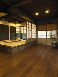 an empty room with wooden floors and windows