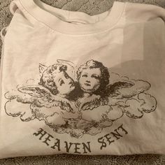 Not Cropped But Not Oversized Brandy Melville Heaven Sent T-Shirt Never Worn White Print Crew Neck Band Merch Top, White Print Band Merch Crew Neck Top, Oversized White Band Merch Top, Angel Heaven, Brandy Melville T Shirts, Prey Animals, Angel Shirt, Brandy Melville Skirts, Deer Shirt