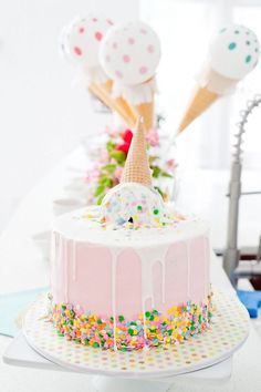 a birthday cake is decorated with sprinkles and ice cream on the top