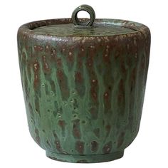 a large green pot with a handle on it