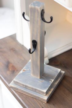 a wooden stand with two black handles on it