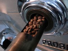 a coffee grinder filled with lots of coffee beans