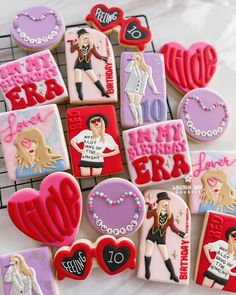 decorated cookies are arranged in the shape of barbies and other items on a cooling rack