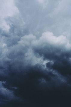 an airplane is flying in the cloudy sky