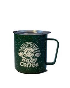 a green coffee mug with the words ruby coffee on it and stars in the background