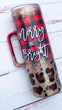 a red and black plaid christmas mug with the words merry and bright on it