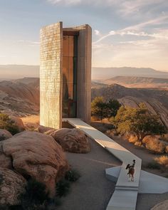 a person riding a horse in front of a tall building on top of a hill