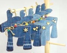 several pieces of denim hanging from a clothes line with gold stars and hearts on them