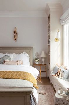 a bedroom with a large bed and white walls