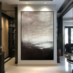 a large black and white painting in a living room