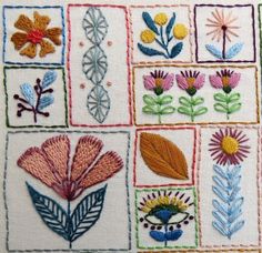 a close up of a piece of cloth with flowers and leaves in squares on it