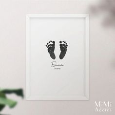 a baby's hand and foot print in a white frame