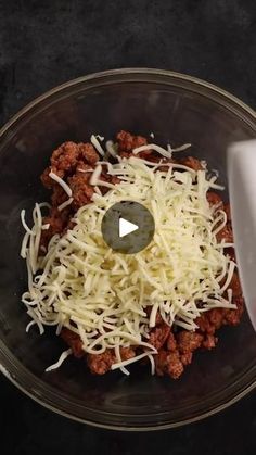 a food processor with cheese and meat in it