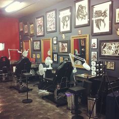 a barber shop with chairs and pictures on the wall behind them, all decorated in black and white