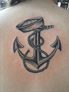 an anchor and rope tattoo on the back of a man