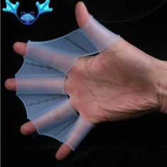 a hand is holding several pieces of white plastic with blue antlers on it and two fingers are pointing towards the camera