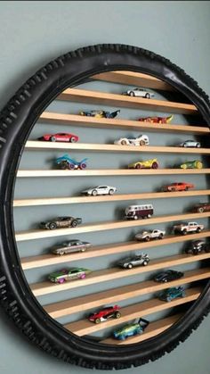 a wall mounted toy car display with wooden shelves in the shape of a tire rim