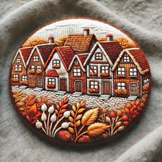 a close up of a button with houses on it