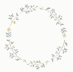 a circular frame with leaves and flowers on it