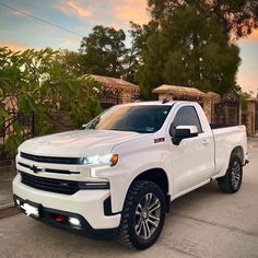 a white truck parked in front of a house