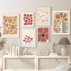 a white table topped with lots of pictures and vases next to a wall filled with books