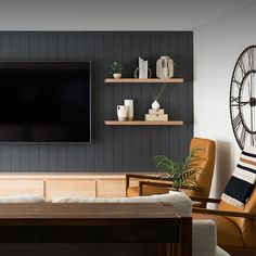 a flat screen tv mounted to the wall in a living room