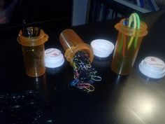 three plastic cups with lids on a table next to other containers and wires in them