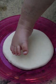 a facebook page with a baby's foot on top of a round cake pan