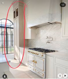 a kitchen with white cabinets and marble counter tops, an oven hood is circled by a red line