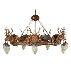 a chandelier with deer heads hanging from it's sides and three lights on each side