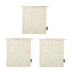 three white linen bags with green handles