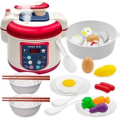 an electric rice cooker with eggs, carrots, and other kitchen items in it