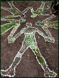 a man made out of shells and beads on the ground